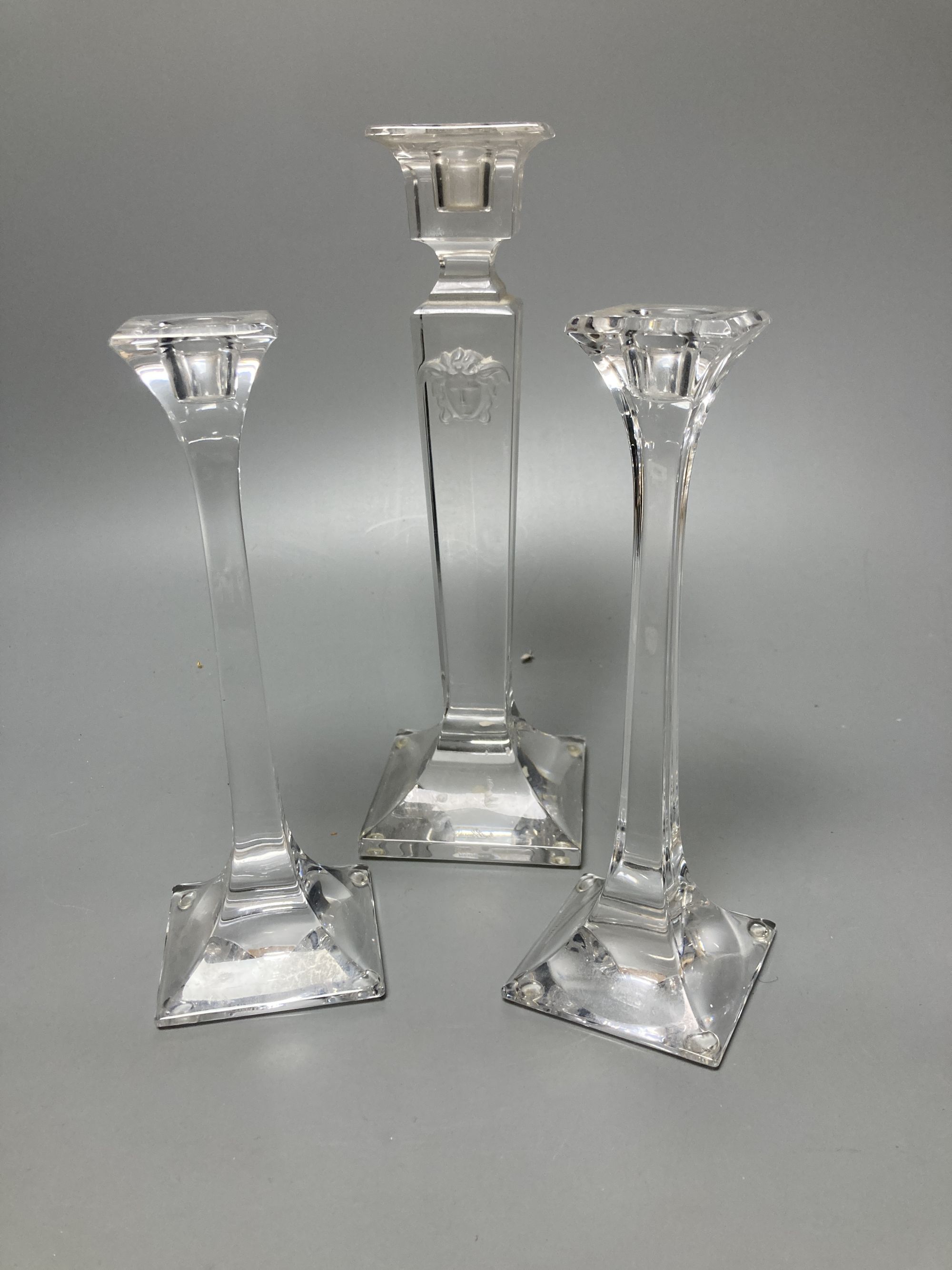 A pair of Tiffany candlesticks and one other (glass)